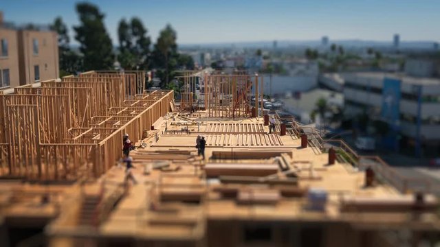Workers building construction site Los Angeles Tilt shift city timelapse 4K