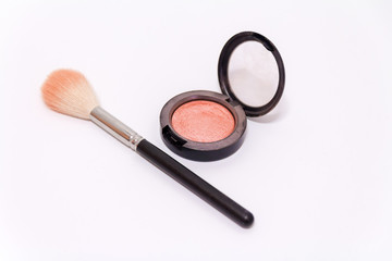 Close up of makeup brush and blush box isolated on white background