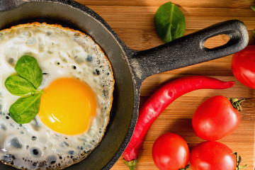 Fried eggs in a frying pan. Rustic breakfast