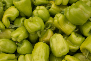 Obraz na płótnie Canvas Fresh Green Bell Peppers on Market Stall For Sale