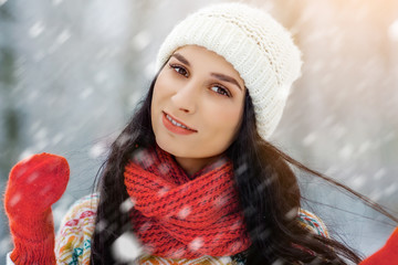 Winter young woman portrait. Beauty Joyful Model Girl laughing and having fun in winter park. Beautiful young woman outdoors. Enjoying nature, wintertime