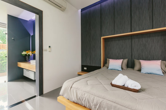 Modern bed room interior in Luxury villa. Open door to bathroom