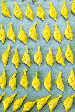 Preparing stuffed pasta tortelli con la coda in Piacenza, Italy