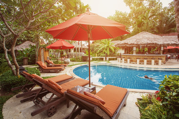 Swimming pool area in luxury hotel resort. Hot summer day, holiday and travel in asia