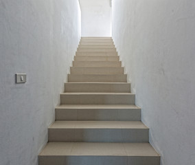 Fototapeta na wymiar White staircase in light villa interior
