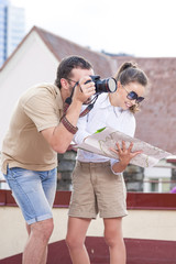 Travel Ideas. Young Happy Caucasian Couple Taking Pictures During Their Trip in City. Posing with Map.