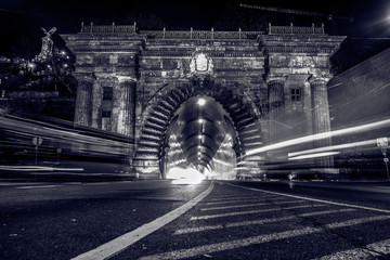 The Buda Castle Tunnel also known as Budai Váralagút at night with cars, Budapest, Hungary