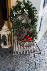 green fir needles in flowerpot decorated with red christmas balls