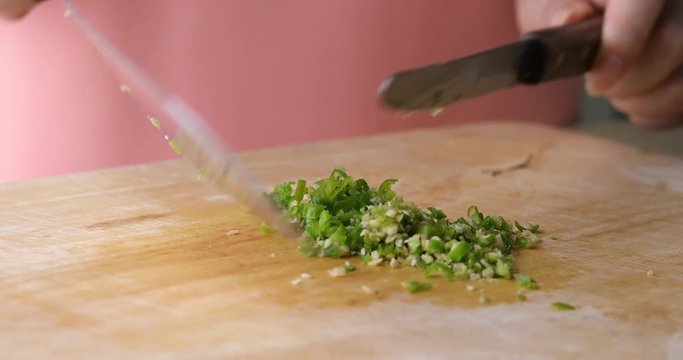 chef cooking food sliced chili with knife on wooden chopping board