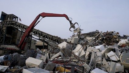 Fototapeta premium scrapyard recycling center creates beautiful manmade landscapes from waste metal using cranes with claws 
