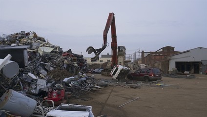 scrapyard recycling center creates beautiful manmade landscapes from waste metal using cranes with...
