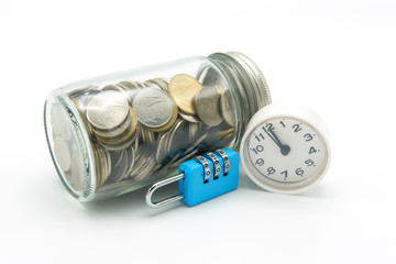 collecting coins (Thai money) in a glass bottle with blue key and clock on isolate white background. as background Saving money concept concept and Security concept with copy space.