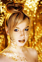 beauty blond woman with gold creative make up