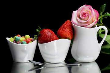 A breakfast of strawberry fruit and cereal.