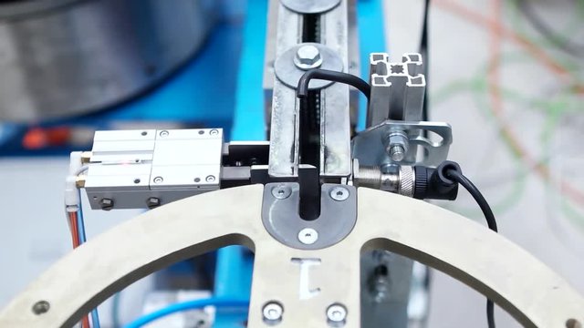 Metal products with screw thread moving on conveyor belt. Auto robotic screw machine