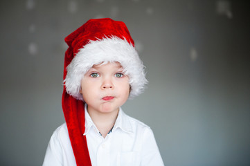 Portrait of cute boy in Christmas hat.