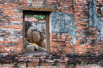 Reclining Buddha at Wat Phut Thai Sawan old temple World Heritage Site in Ayutthaya, Thailand.