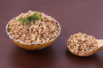 Cooked buckwheat. Healthy lunch. Brown background