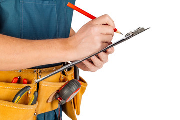 builder in with clipboard over white wall background. . repair, construction, building, people and maintenance concept.