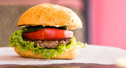 Large sandwich with tomato on the table