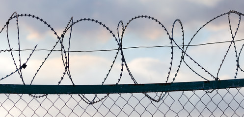 Fence with barbed wire as a background