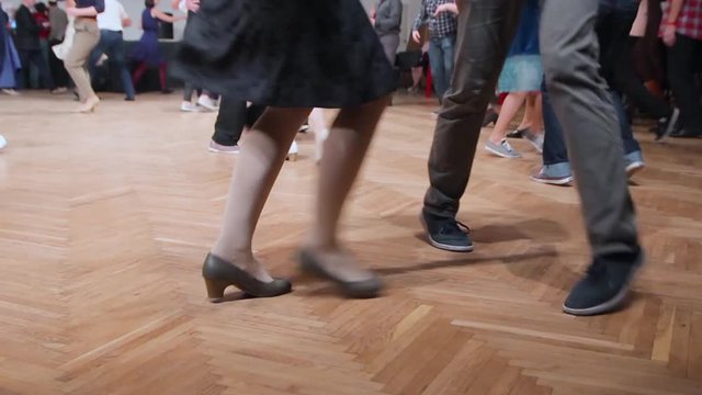 Dancers perform lindy hop dance at the swing festival. Dancing legs close up.
