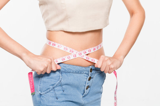Close Up Woman measuring her waistline with measure line
