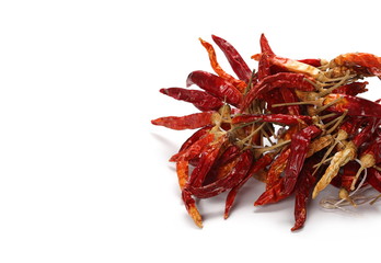 Dry tied red hot chili peppers, pile isolated on white background