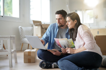 Couple choosing paint colours to reform house