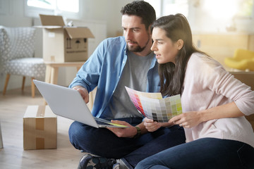 Couple choosing paint colours to reform house