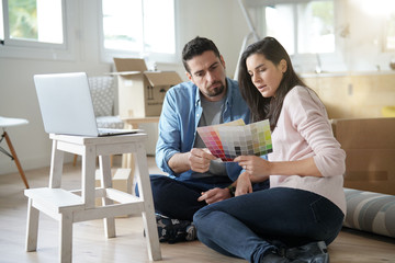 Couple choosing paint colours to reform house