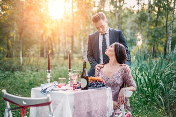 Dinner at sunset. Beautiful couple man and woman.