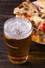 Glass of beer and pizza. Ale and food