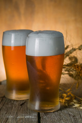Beer in frosty mugs on rustic background