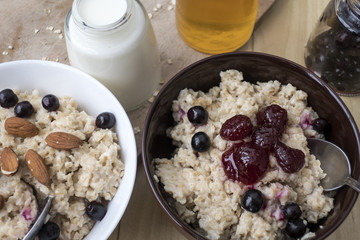Delicious oatmeal porridge with berry and almonds for breakfast.
