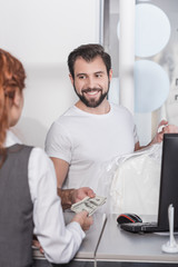dry cleaning manager taking money for work from customer