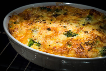 Casserole with broccoli and cheese right from the oven, true looking
