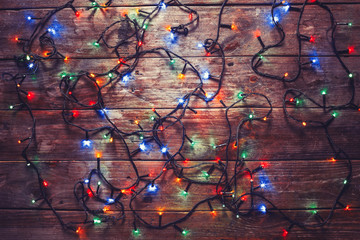 Colorful New Year Electric Garland On A Wooden Wall, Top View