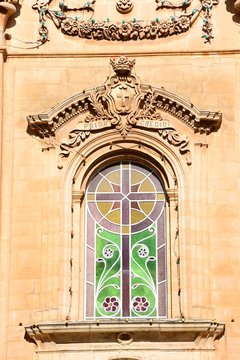 Ornate stained glass window on the front of Naxxar Parish church, Naxxar, Malta.