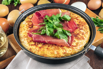 A closeup photo of a Spanish tortilla with ingredients