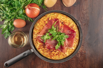Spanish tortilla with wine, ingredients, and copy space