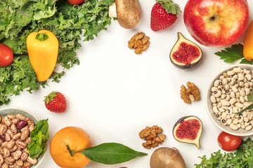 Vibrant fresh vegetables, fruits, cereals, and mushrooms on white background with copyspace