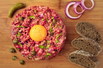 Overhead closeup photo of steak tartare with garnish