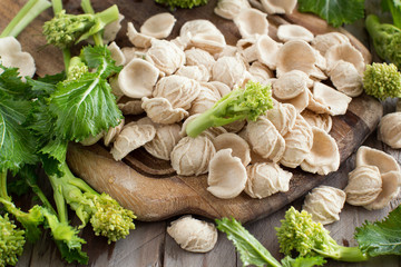 Raw homemade Orecchiette pasta and turnip greens