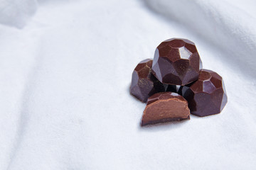 handmade chocolates  lie on white textil background table. handmade sweets
