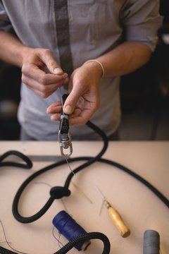 Worker preparing leather straps