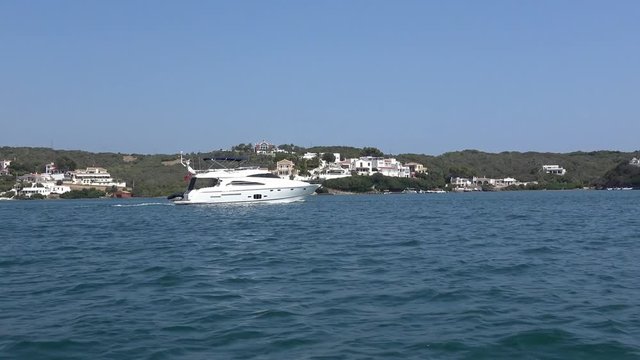 Motor luxury boat slowly crossing Menorca Waters