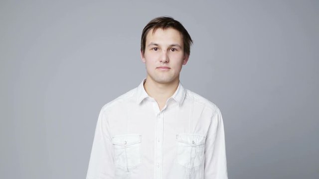 Negating Man waving his finger telling No, over grey background