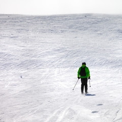 Fototapeta na wymiar Skier downhill on snowy off-piste slope