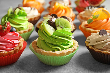 Tasty colorful cakes on table